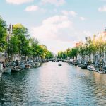 The Amsterdam canal with blue skies above