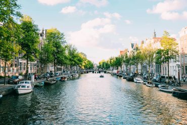 The Amsterdam canal with blue skies above