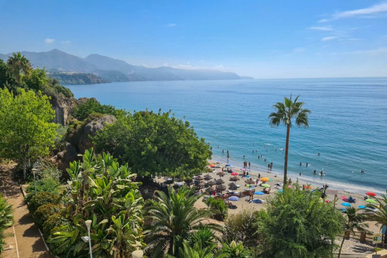 A beach with lush trees just behind on the Costa Del Sol
